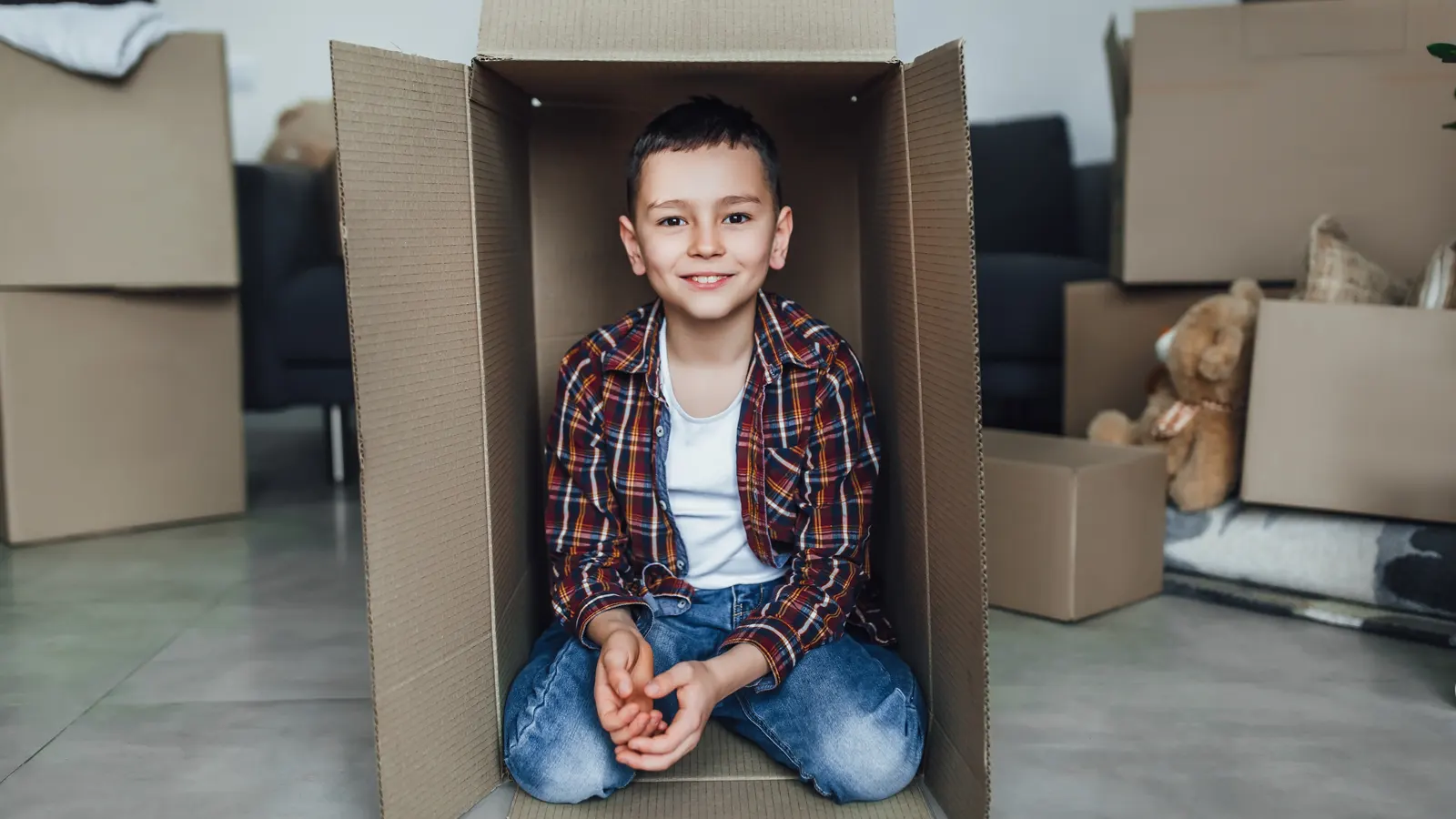 Young boy inside a cardboard box