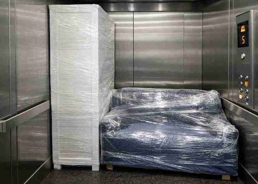 a closet and a couch in an elevator