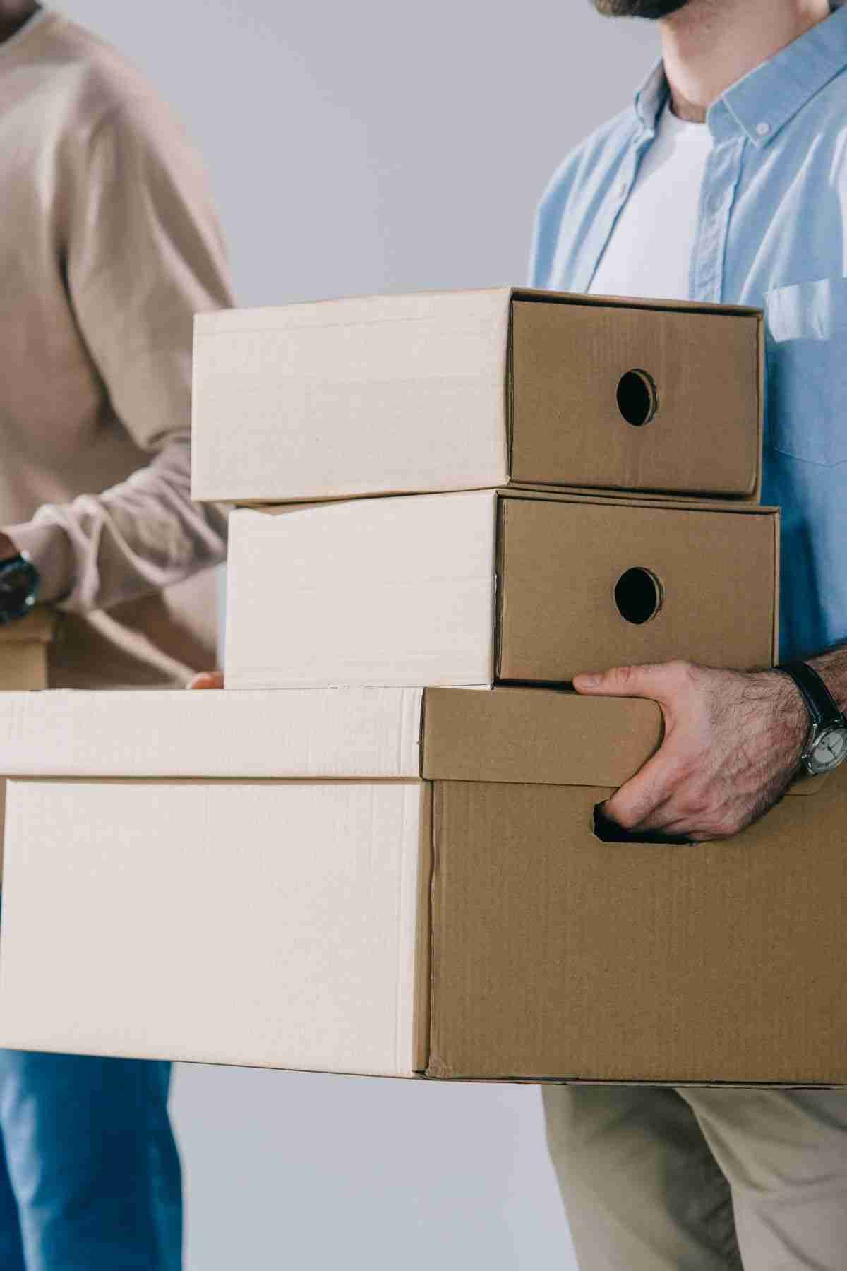 a person carrying boxes for moving