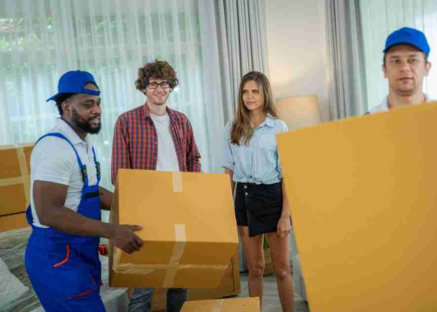 movers carrying boxes into a home to unpack