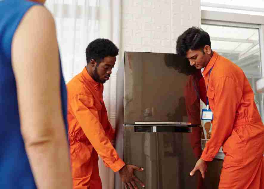 two experts lifting a fridge
